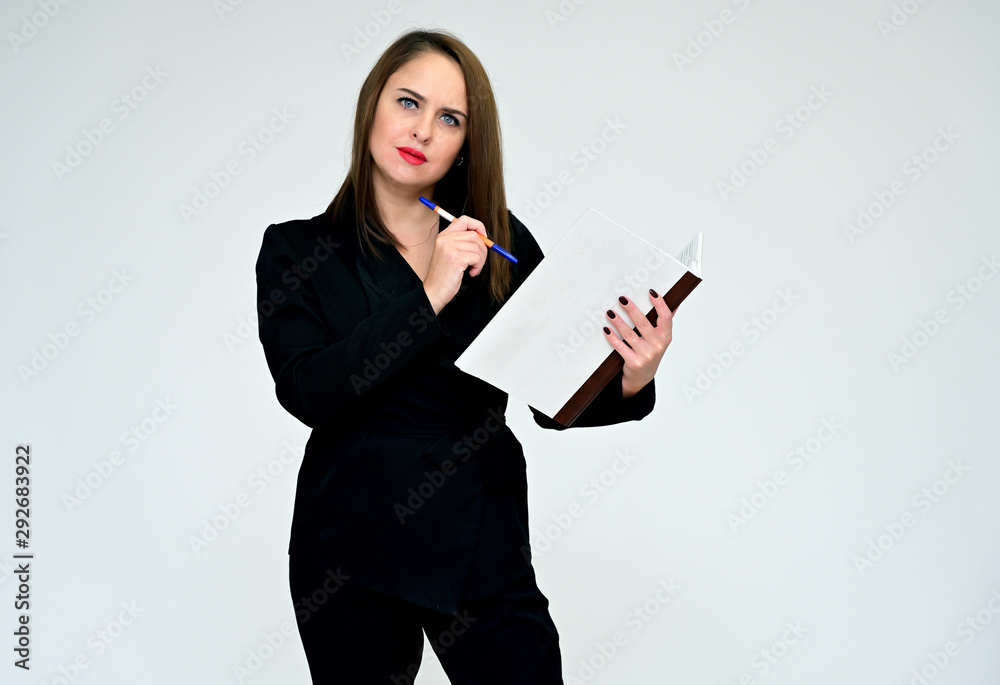 Portrait on a white background of a pretty adult executive brunette woman in black business suit. Serious business look and communication. Portrait on a white background of a pretty adult executive brunette woman in black business suit. Serious business look and communication.