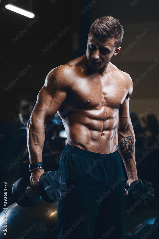 Handsome strong athletic men pumping up muscles workout fitness and  bodybuilding concept background - muscular bodybuilder fitness men doing  arms abs back exercises in gym naked torso. Stock Photo | Adobe Stock