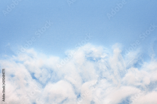 Siliconized hollowfiber, polyester fiber on a blue background with copy space, used as a filler for blankets, pillows, clothes and upholstered furniture