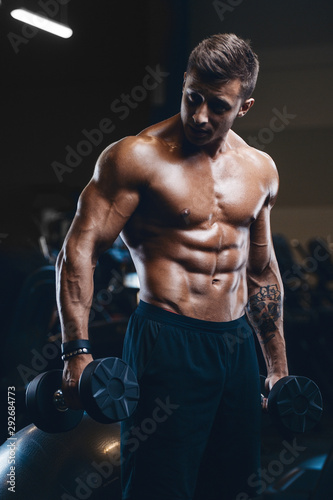 Handsome strong athletic men pumping up muscles workout fitness and bodybuilding concept background - muscular bodybuilder fitness men doing arms abs back exercises in gym naked torso.