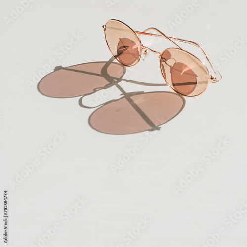 Modern women's sunglasses on white table. Fashion blog hero header background.