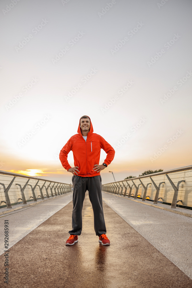 Fit young man standing on a bridge