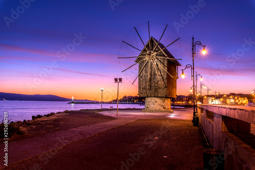 Old windmill at night ancient town of Nesebar in Bulgaria.
