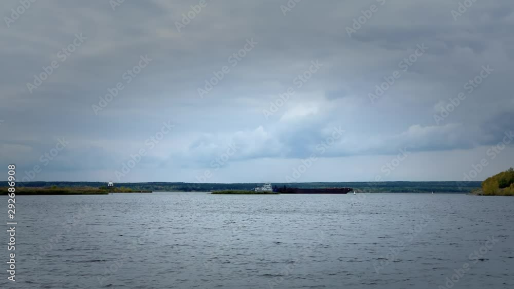 NABEREZHNYE CHELNY, RUSSIA - SEPTEMBER, 29, 2018: Tug that is dragging large ship. 3840x2160 UHD Free footage stoke NABEREZHNYE CHELNY, RUSSIA - SEPTEMBER, 29, 2018: Tug that is dragging large ship. 3840x2160 UHD Free footage stoke