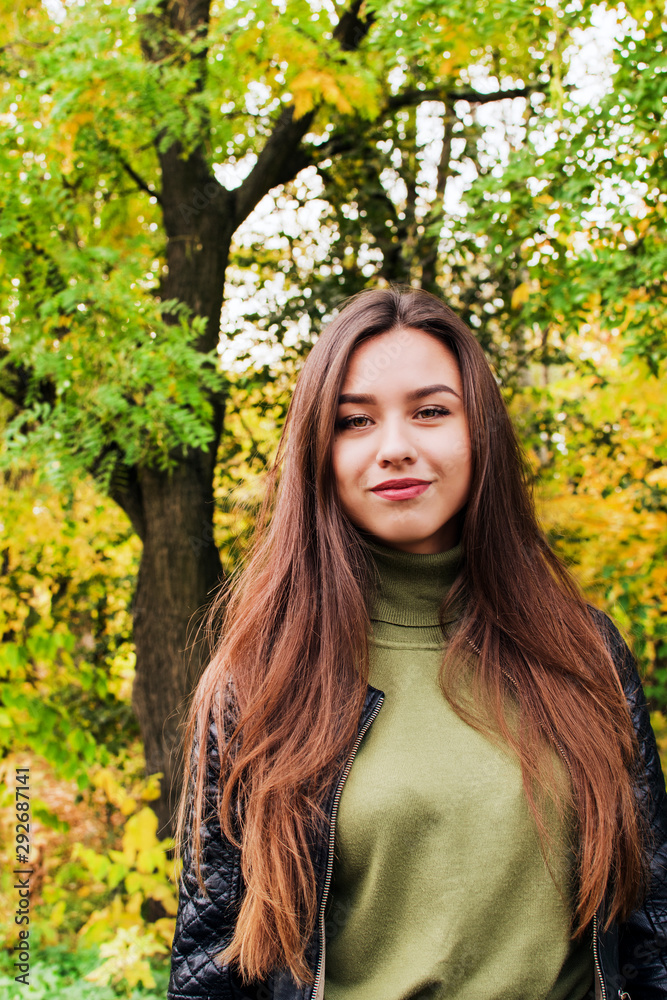 Girl in a wreath of autumn maple leaves. Queen and Autumn leaf fall. Beautiful, thoughtful, dreamy, enigmatic smile. The girl in the red dress. Woman with wreath of leaves on a head, outdoor portrait Girl in a wreath of autumn maple leaves. Queen and Autumn leaf fall. Beautiful, thoughtful, dreamy, enigmatic smile. The girl in the red dress. Woman with wreath of leaves on a head, outdoor portrait