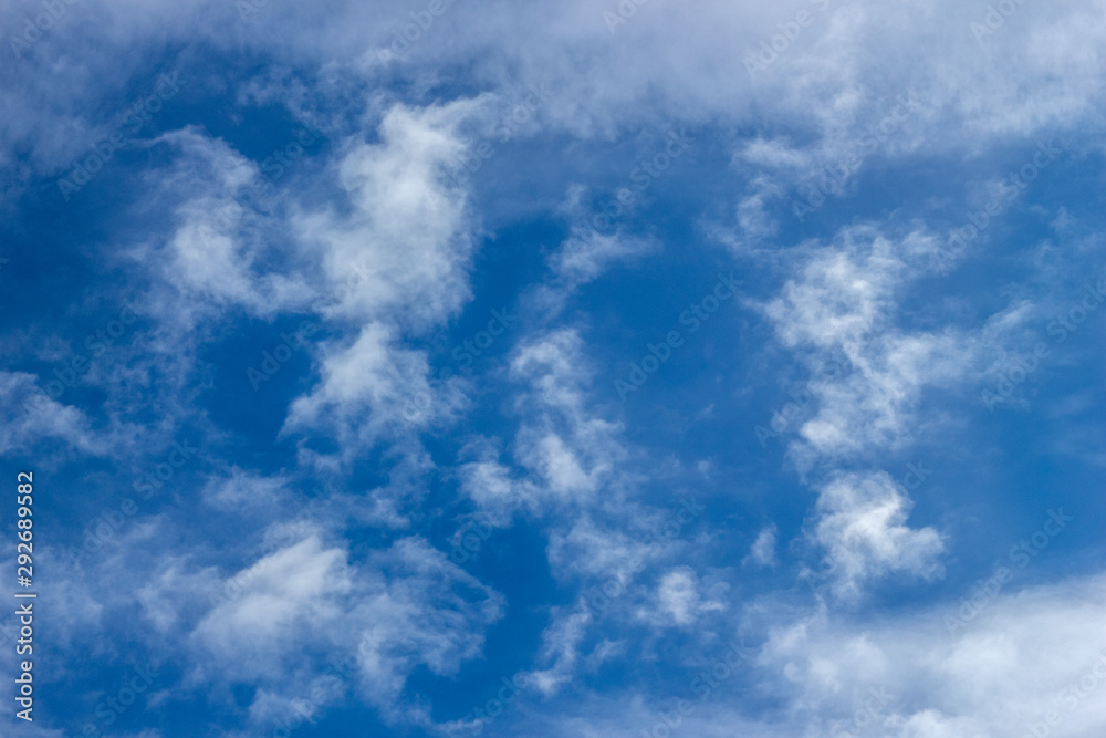 Blue sky with white clouds closeup.