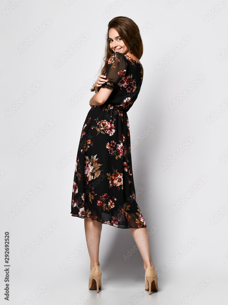 Slim curly female model in a silk dress looking at the camera in full growth. Cute girl in romantic clothes is going on a date Slim curly female model in a silk dress looking at the camera in full growth. Cute girl in romantic clothes is going on a date