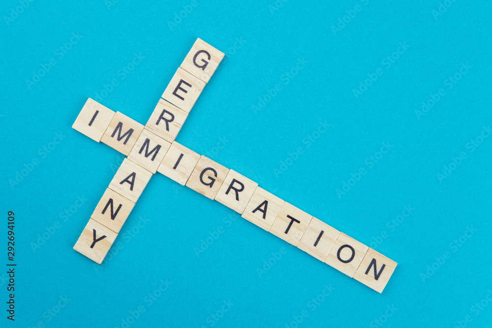 Immigration minimalistic concept. Isolated wooden letter blocks with word cloud Immigration to Germany Immigration minimalistic concept. Isolated wooden letter blocks with word cloud Immigration to Germany