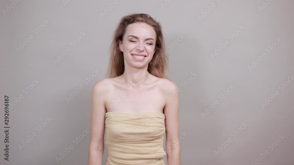 Beautiful girl in beige t-shirt over isolated white background shows emotions Beautiful girl in beige t-shirt over isolated white background shows emotions