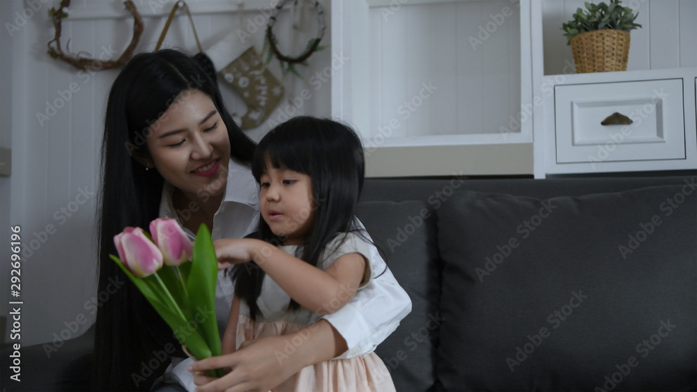 Holiday concept. The daughter is bringing flowers to surprise her mother's birthday. 4k Resolution. Holiday concept. The daughter is bringing flowers to surprise her mother's birthday. 4k Resolution.