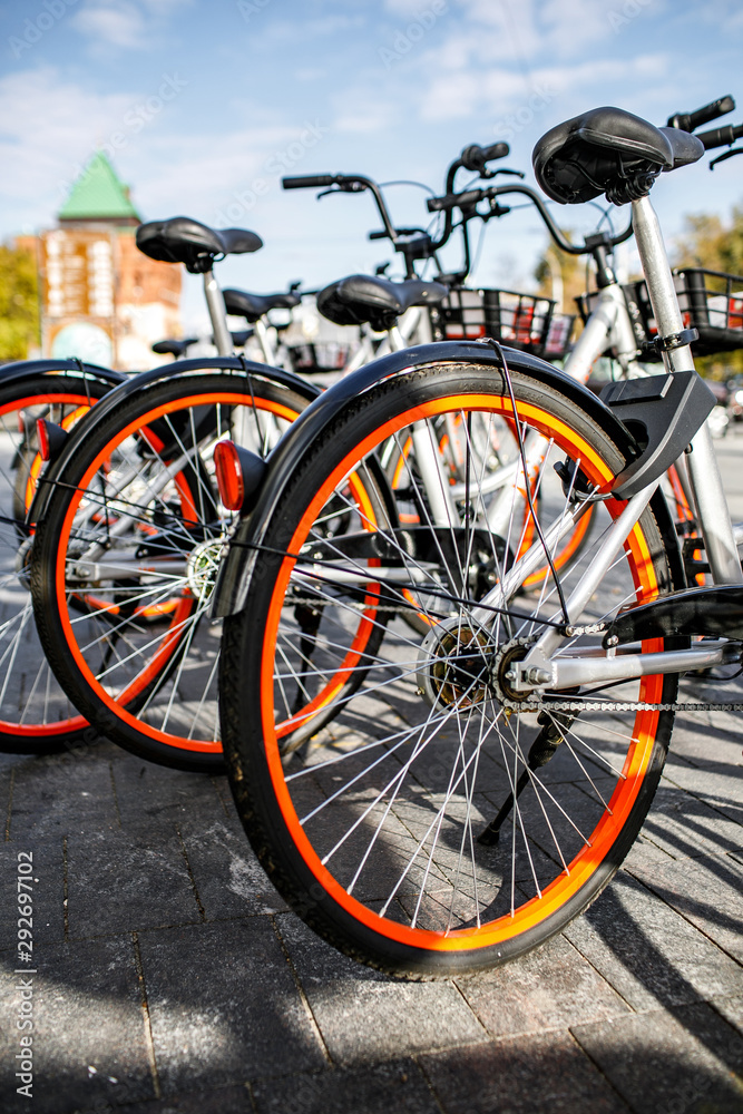 Bicycle rental service on city road parking with sunlight, public transportation concept. Eco life