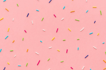 trendy pattern of colorful sprinkles for background of design banner, poster, flyer, card, postcard, cover, brochure over pink