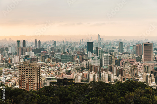 Aerial panorama over Downtown Taipei with layers of mountain in background in the dusk from Xiangshan Elephant Mountain in the evening.