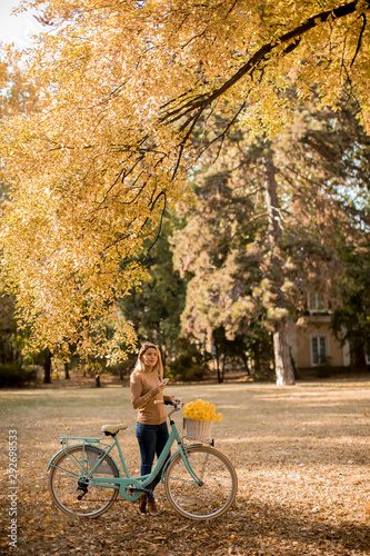Young woman with bicycle us...