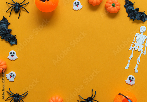 Halloween holiday concept, Pumpkin, bats, white skeleton and tiny ghost in orange background with copy space for text, Top flat view wallpaper