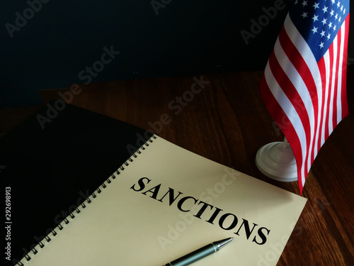 Fotografie American sanctions and USA flag on table.