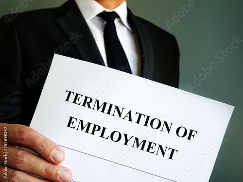 Fotografia Man is holding Termination of employment papers.