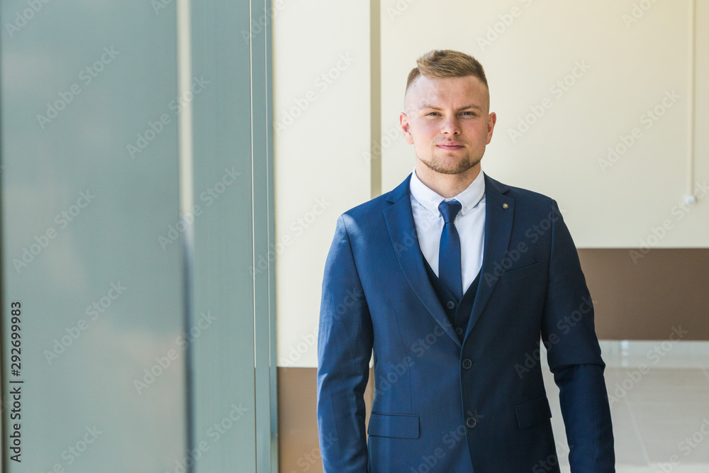 portrait of a young purposeful businessman in a suit portrait of a young purposeful businessman in a suit