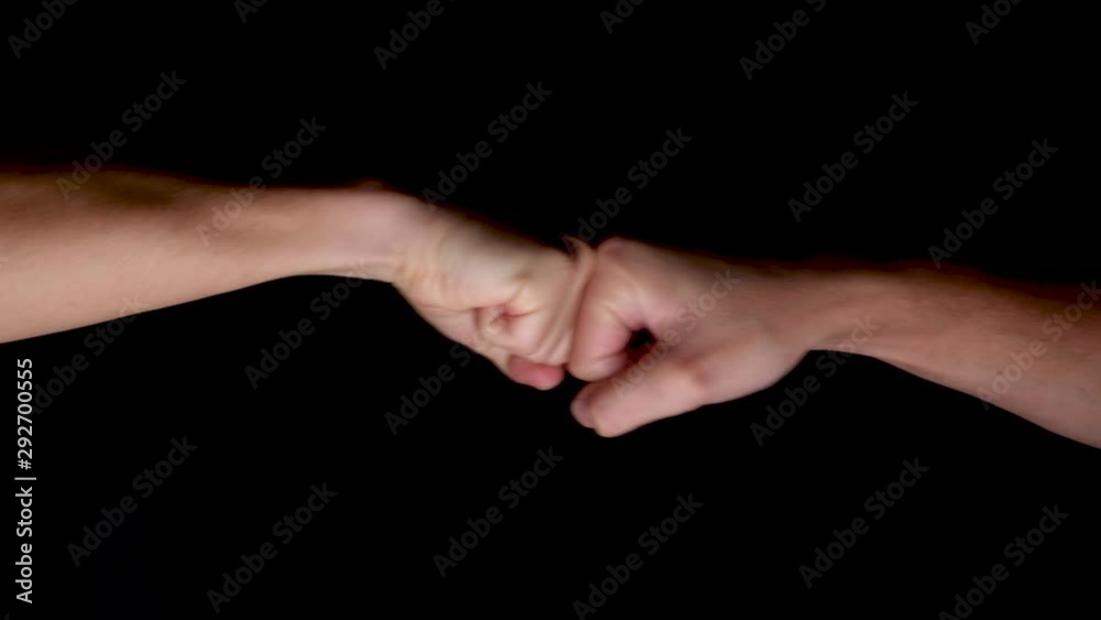Slow Motion FIst Bumps Against Black Background. Locked Off Slow Motion FIst Bumps Against Black Background. Locked Off