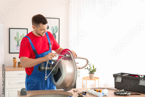 Plumber installing sink in ...