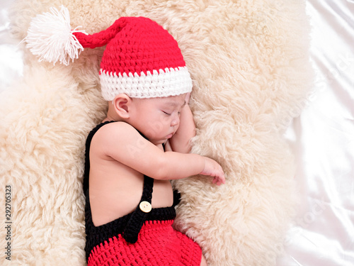 cute four-month baby santa with Christmas red dress