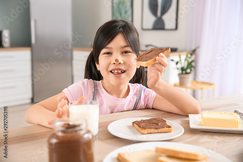 Happy asian child eating ch...