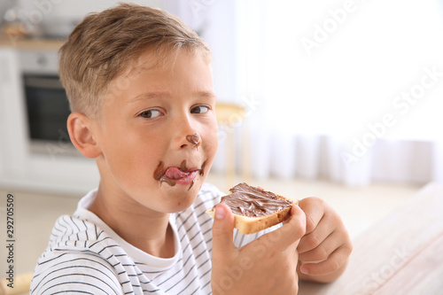 Funny little boy eating tas...