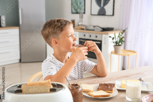 Funny little boy eating tas...