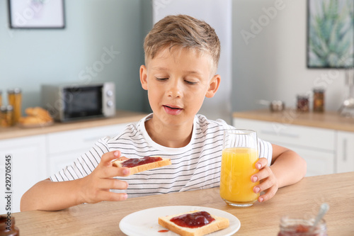 Funny little boy eating tas...