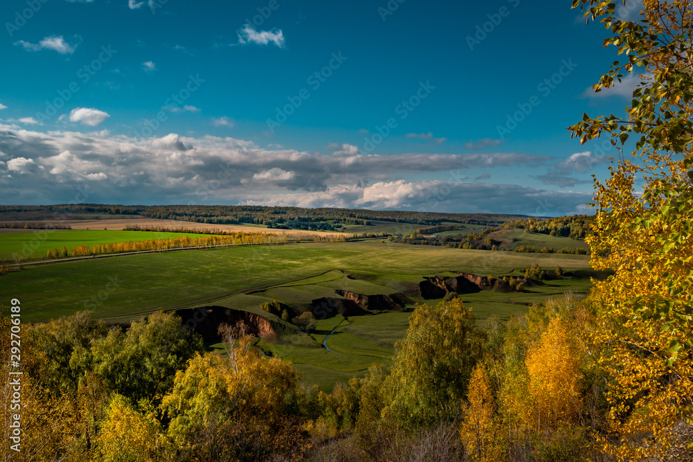 Obraz premium autumn landscape with river and blue sky