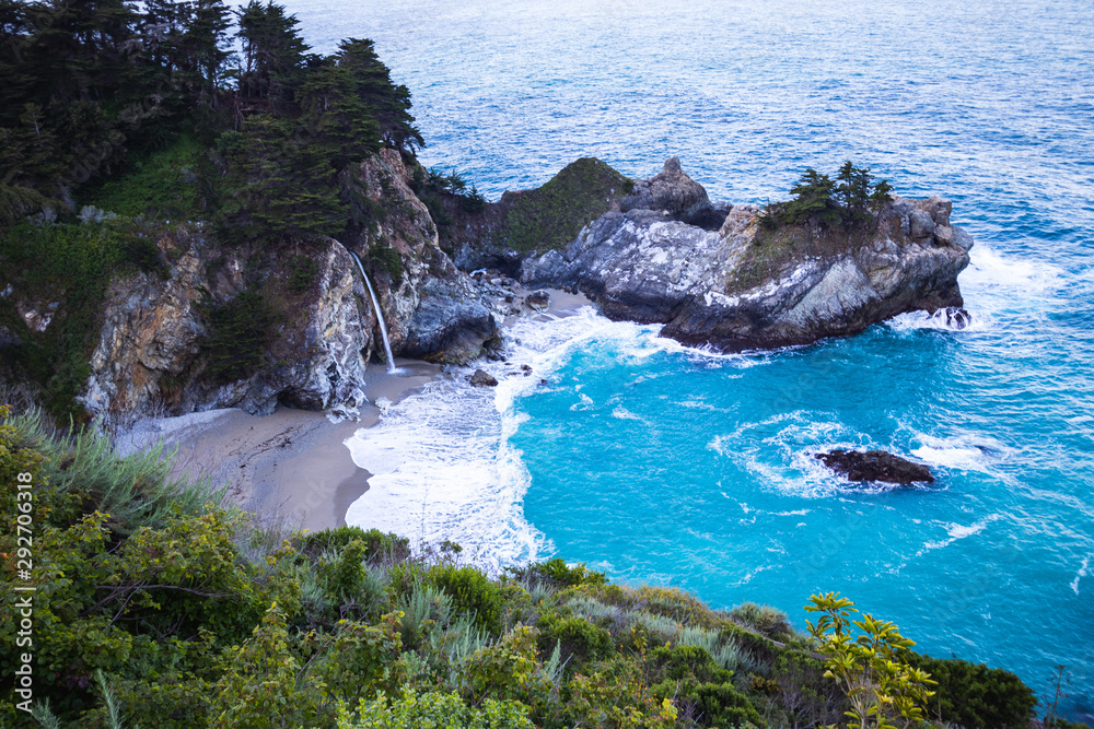 McWay Falls is a waterfall on the coast of Big Sur in central California that flows year-round from McWay Creek in Julia Pfeiffer Burns State Park. Travel USA, tourism, beautiful lanscape, coastline