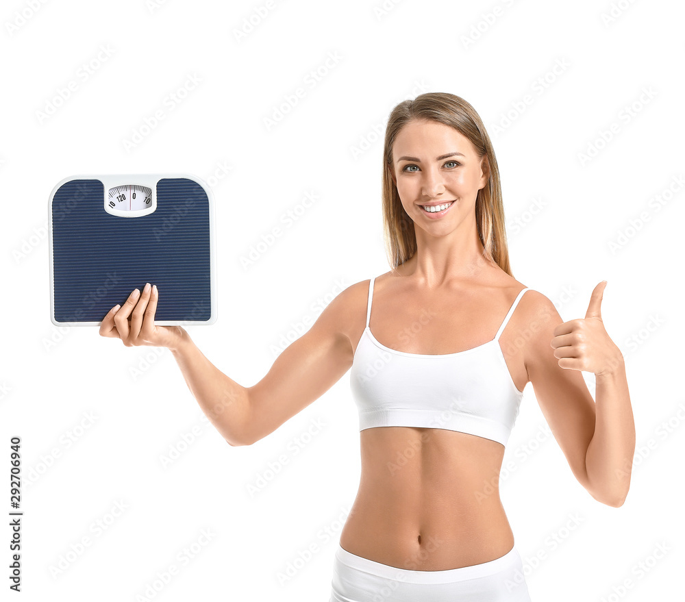 Beautiful young woman with scales showing thumb-up on white background. Weight loss concept Beautiful young woman with scales showing thumb-up on white background. Weight loss concept