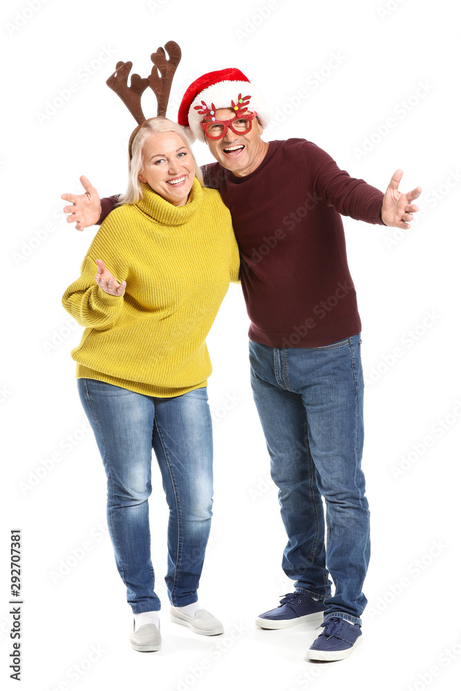 Portrait of happy mature couple with Christmas decor on white background Portrait of happy mature couple with Christmas decor on white background