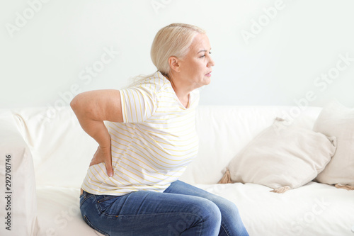 Mature woman suffering from back pain at home © Pixel-Shot