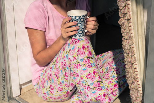 girl in pajamas with a cup of coffee (ID: 292708794)