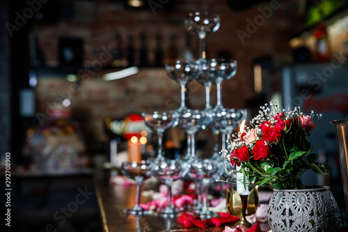 Closeup Table setting, adorned with flowers. Floral decoration for romance dining. Wedding banquet , festive decor. Concept of service and catering.