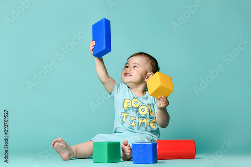 Fototapeta little boy child toddler playing with block toys