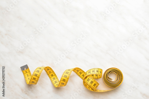 Measuring tape on light background photo