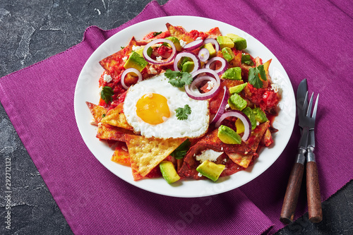 nachos with a fried egg and tomato sauce