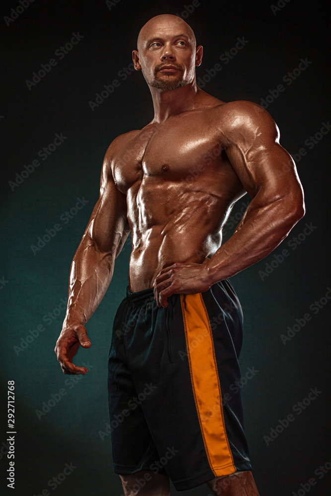 Obraz premium Bodybuilding competitions on the scene. Handsome and fit man sportsmen bodybuilder physique and athlete. Men's fitness and sport motivation. Individual sports recreation.