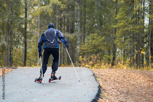 Man Cross-country skiing with roller skis in the Park