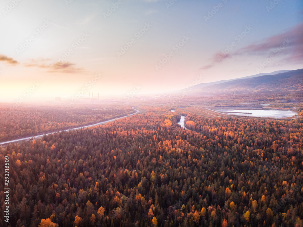 Beautiful autumn forest with yellow and red trees, blue mountain river sunset, aerial view