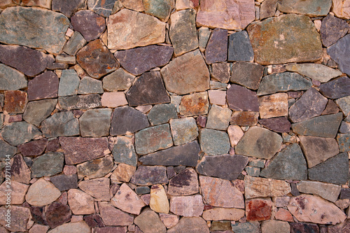 Detail of a natural stone wall, as a background photo