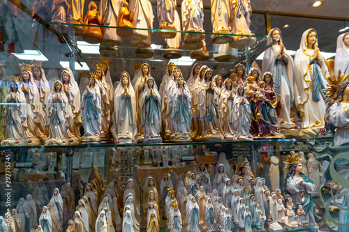 Fotografija statues or figurines in a shop, the commercial side of Lourdes.