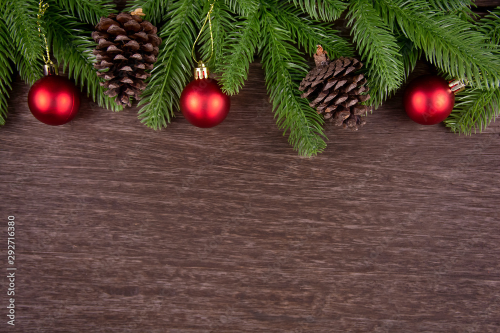 Christmas decorations with branches of fir tree, christmas ball and Pine cones on wooden background. copy space Christmas decorations with branches of fir tree, christmas ball and Pine cones on wooden background. copy space