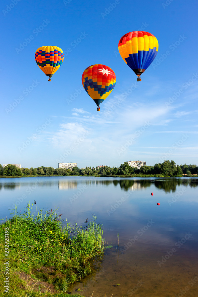 Fototapeta premium Balloon flying over the lake.