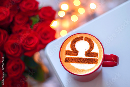 white cup of coffee with the symbol of the zodiac Libra