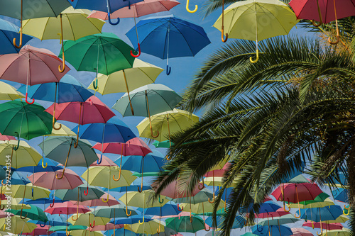 umbrella of different colors floating in the sky, copy-space photo