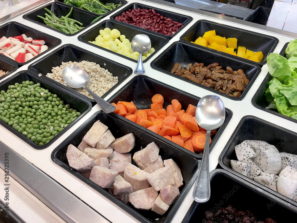 Fresh salad bar with various fresh assortment of ingredients, fruits and proteins Variety of vegetable set for display space of the options for the choice of clients in the supermarket. Take yourself