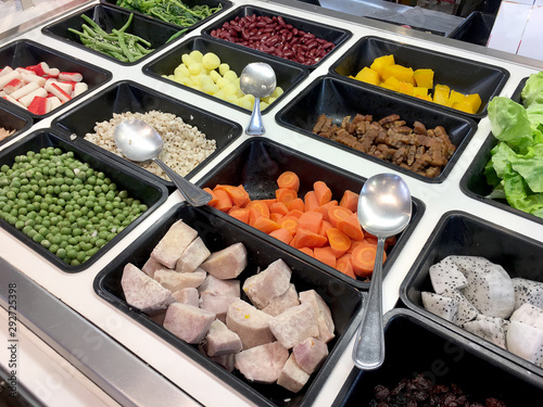 Fresh salad bar with various fresh assortment of ingredients, fruits and proteins Variety of vegetable set for display space of the options for the choice of clients in the supermarket. Take yourself